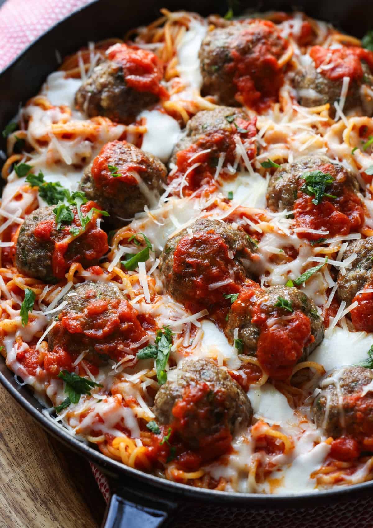 Baked Spaghetti topped with cheese, sauce and loaded with meatballs.