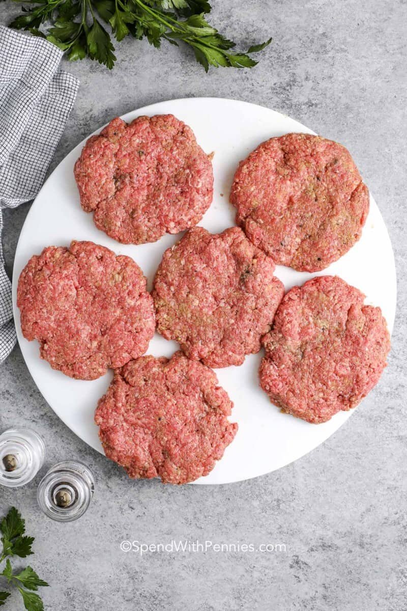 raw salisbury steak patties on a plate