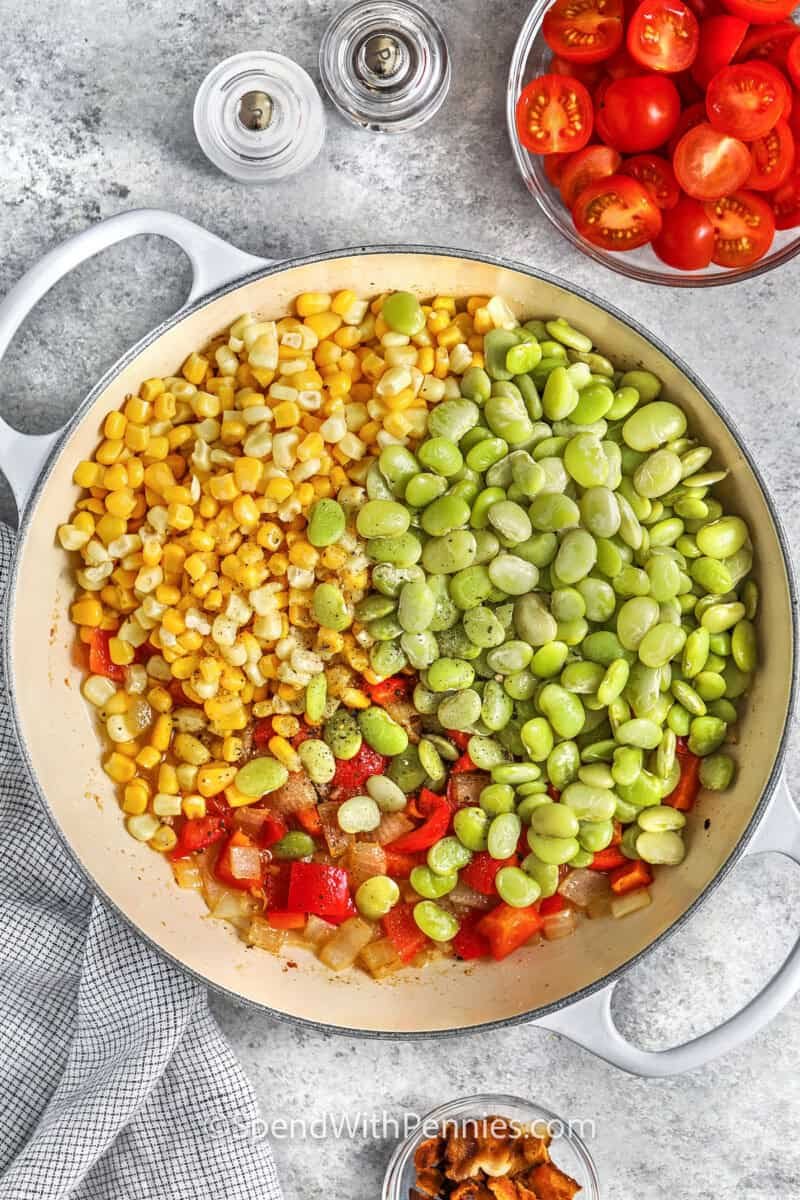 adding vegetables to pot to make Succotash