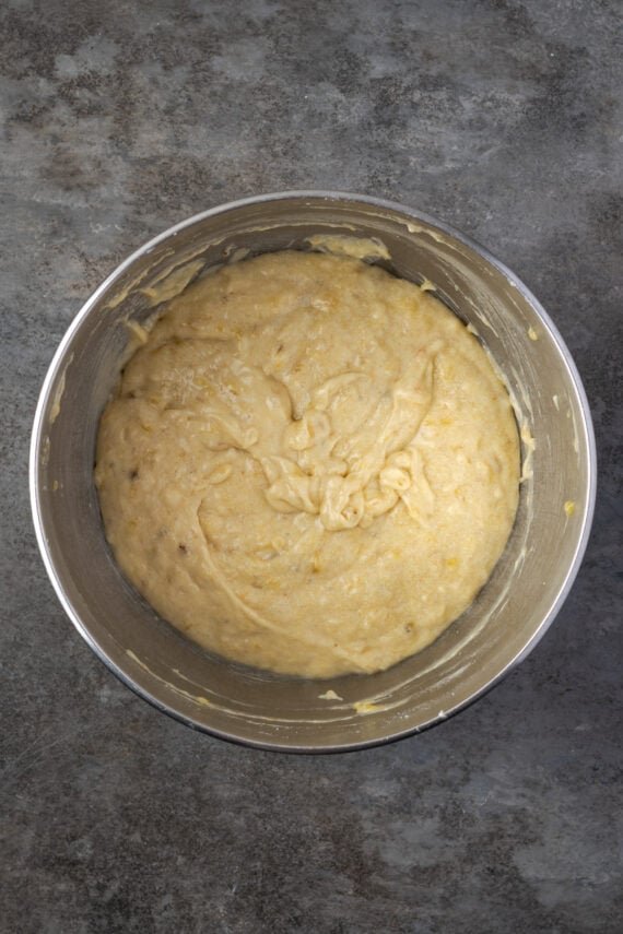 Banana cupcake batter in a metal mixing bowl.