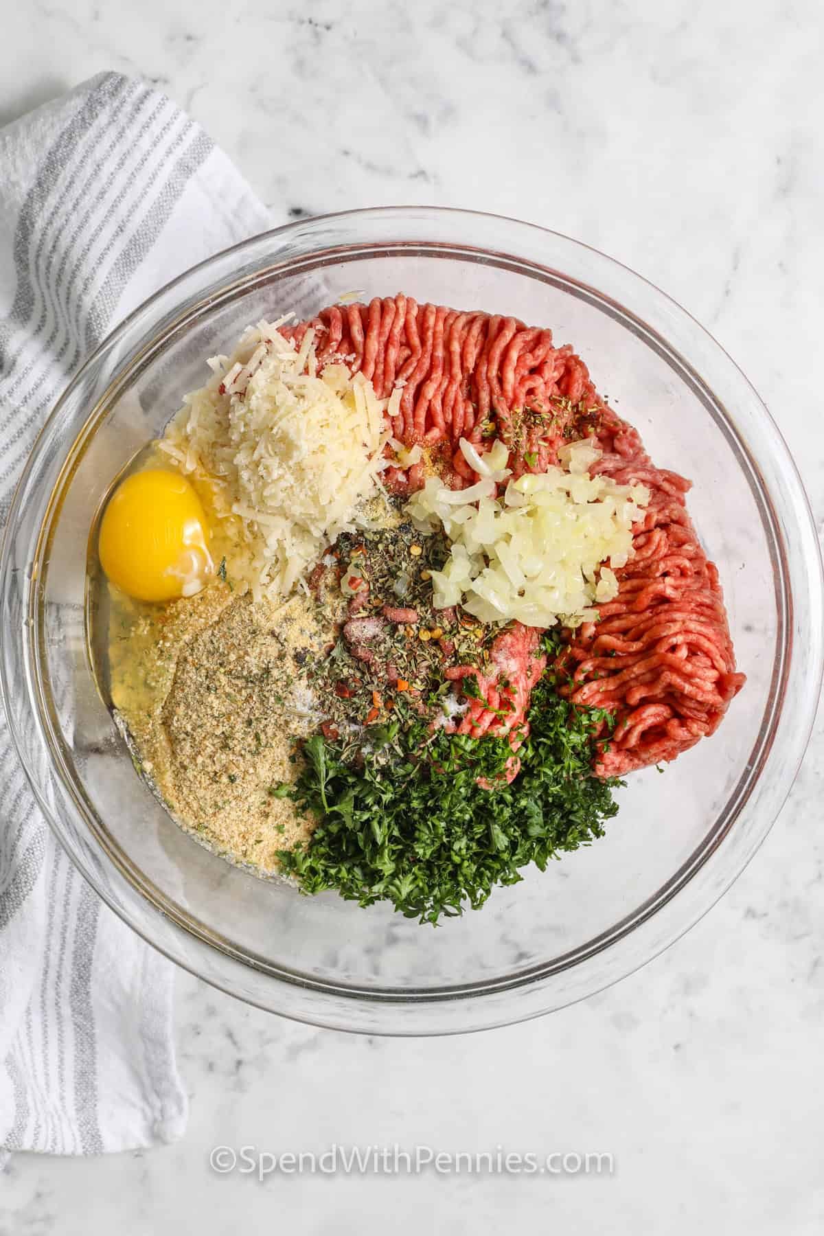 adding ingredients to bowl to make Easy Meatball Recipe