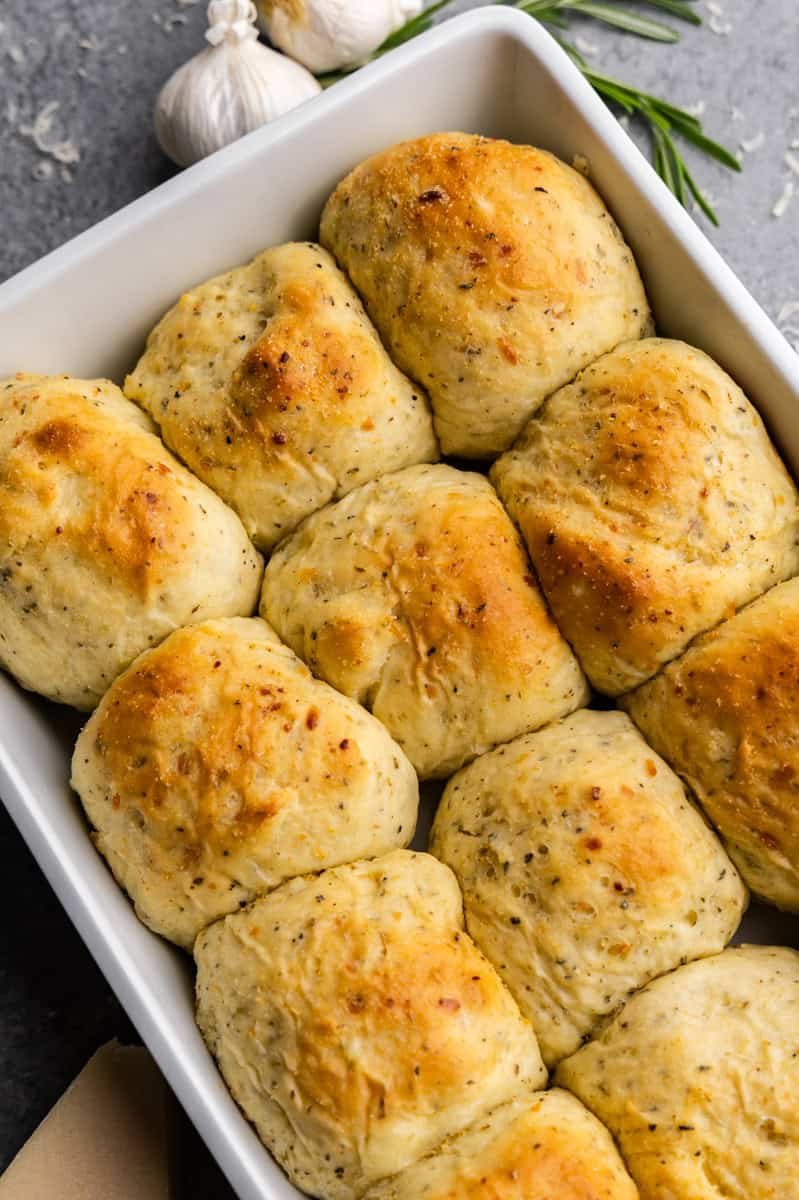 garlic parmesan herb dinner rolls in large white pan