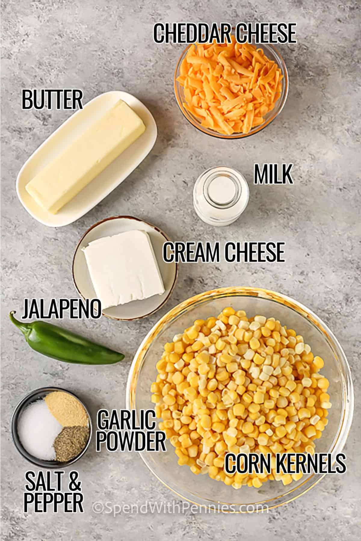 creamed corn ingredients including cheddar cheese, butter, milk, cream cheese, jalapeno, garlic powder, corn kernels, salt, and pepper