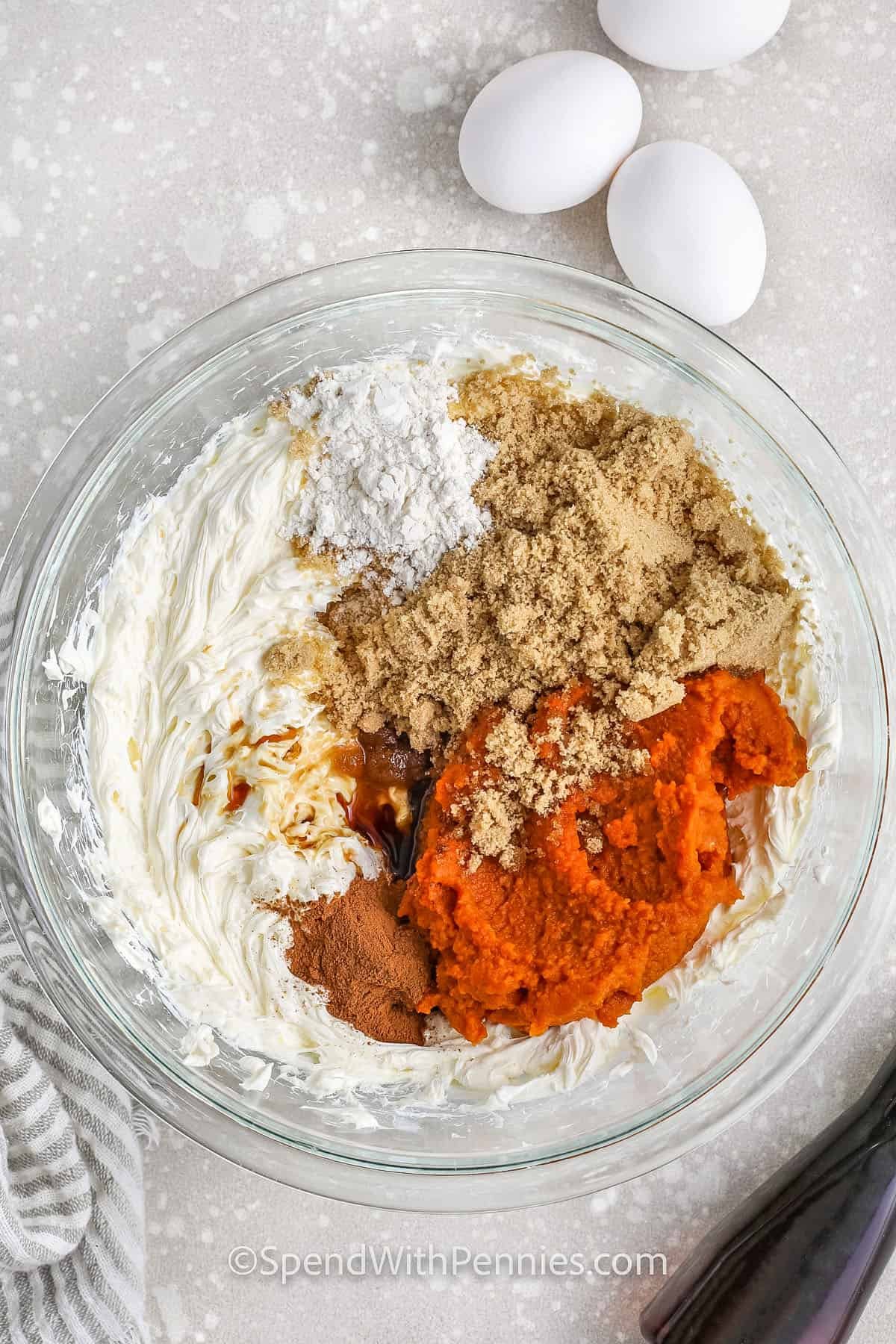 adding ingredients to bowl to make filling for Pumpkin Cheesecake Bars