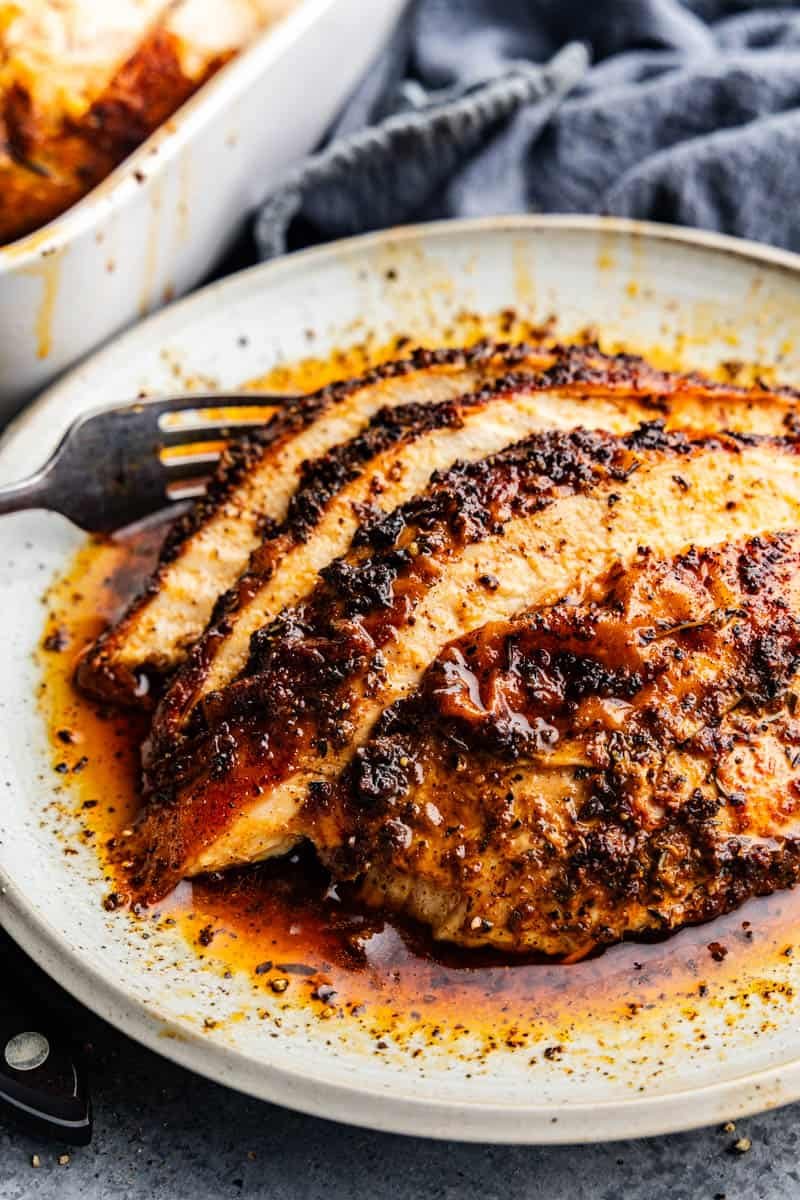 Servings of sliced cajun roasted turkey breast on a plate.