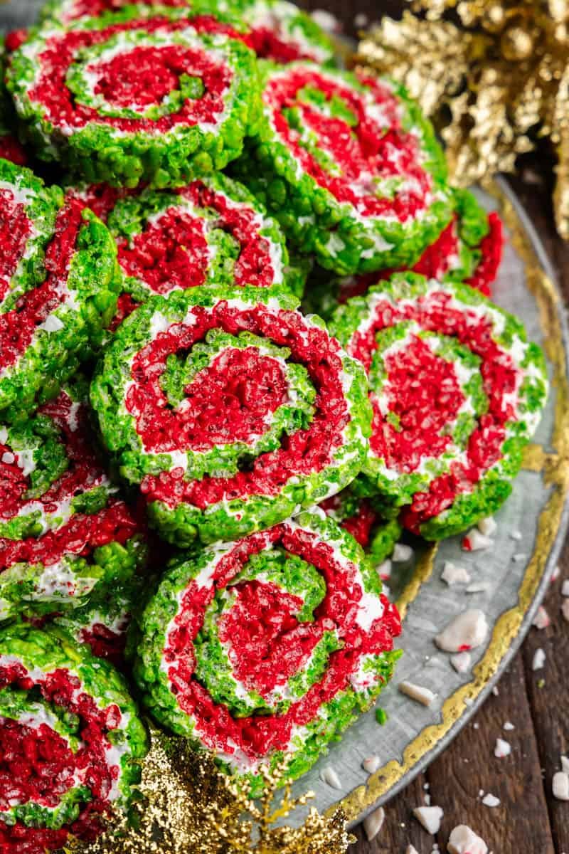 An overhead view of a platter of slices of Christmas rice krispie treat pinwheels, with layers of red, green, and white.