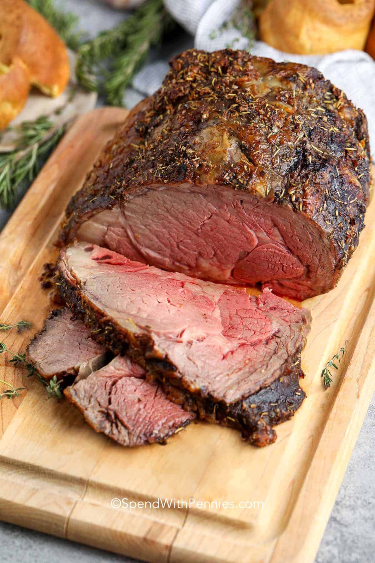 Prime Rib cooked on a cutting board cut into slices